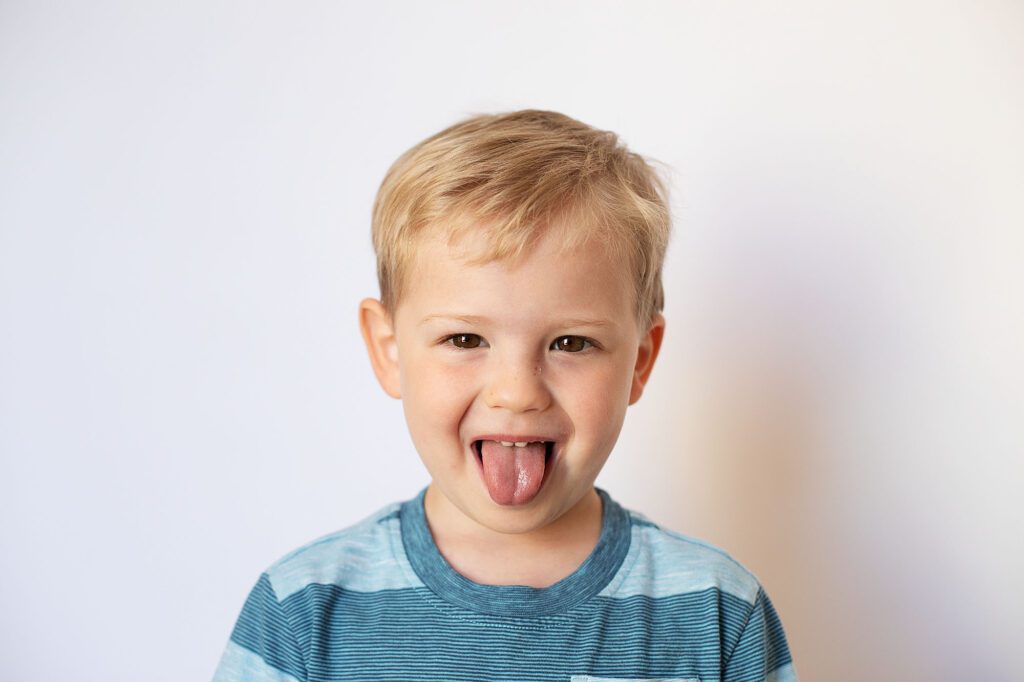 boy sticking out tongue at annapolis preschool photographer