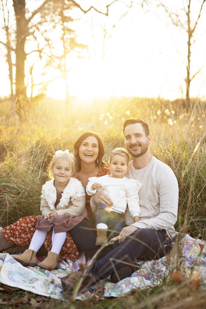 family smiling at baltimore family photographer during golden hour session