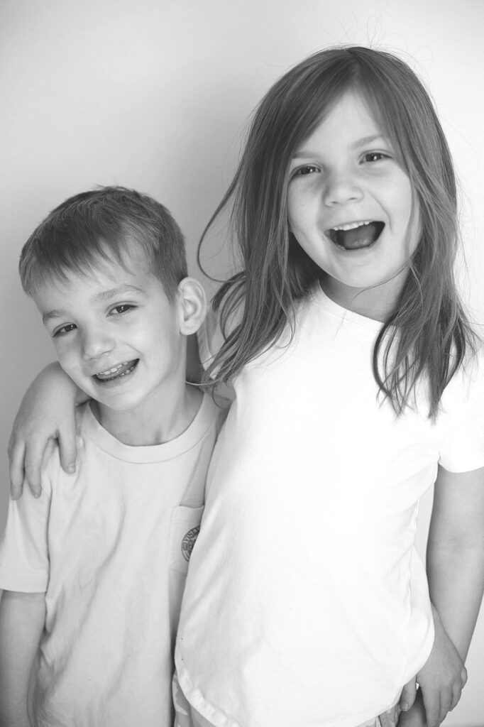 siblings laughing together during school picture day in columbia md