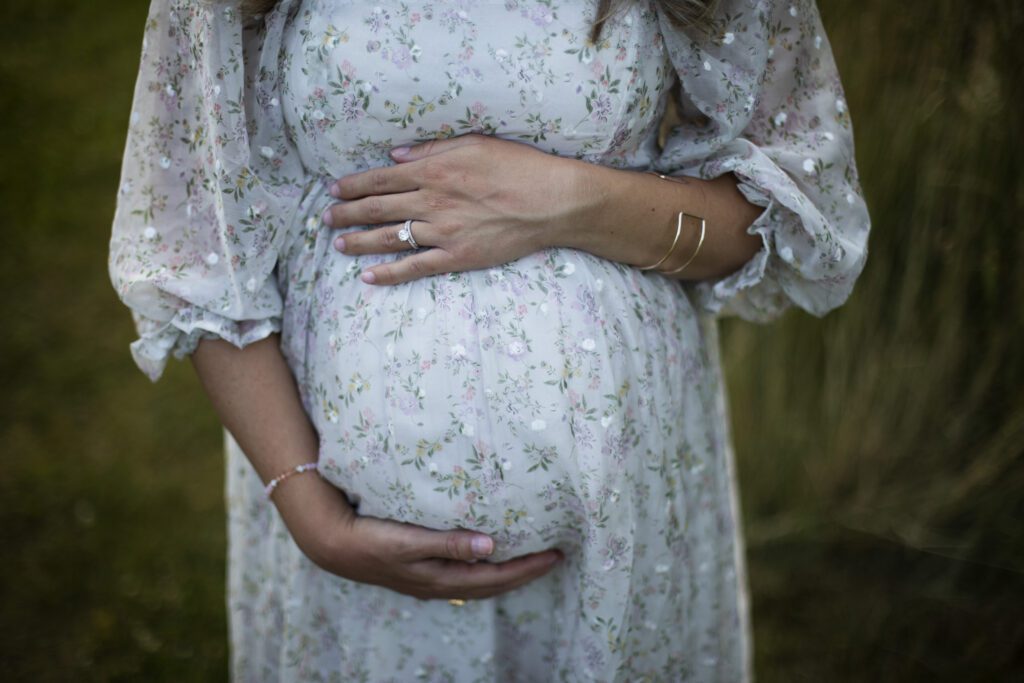 mom holding her bump during baltimore maternity session