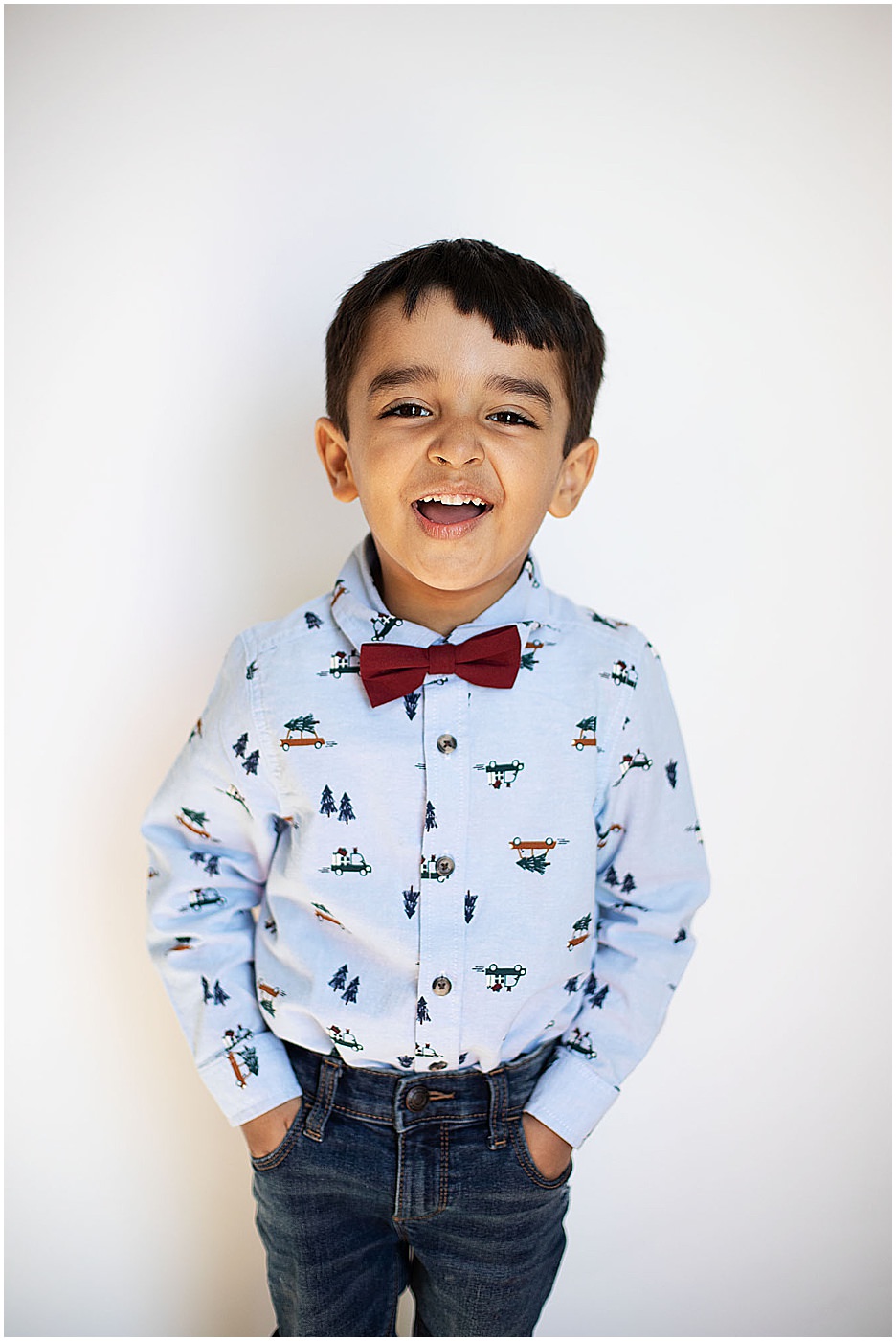boy in bowtie laughing at camera baltimore school photographer