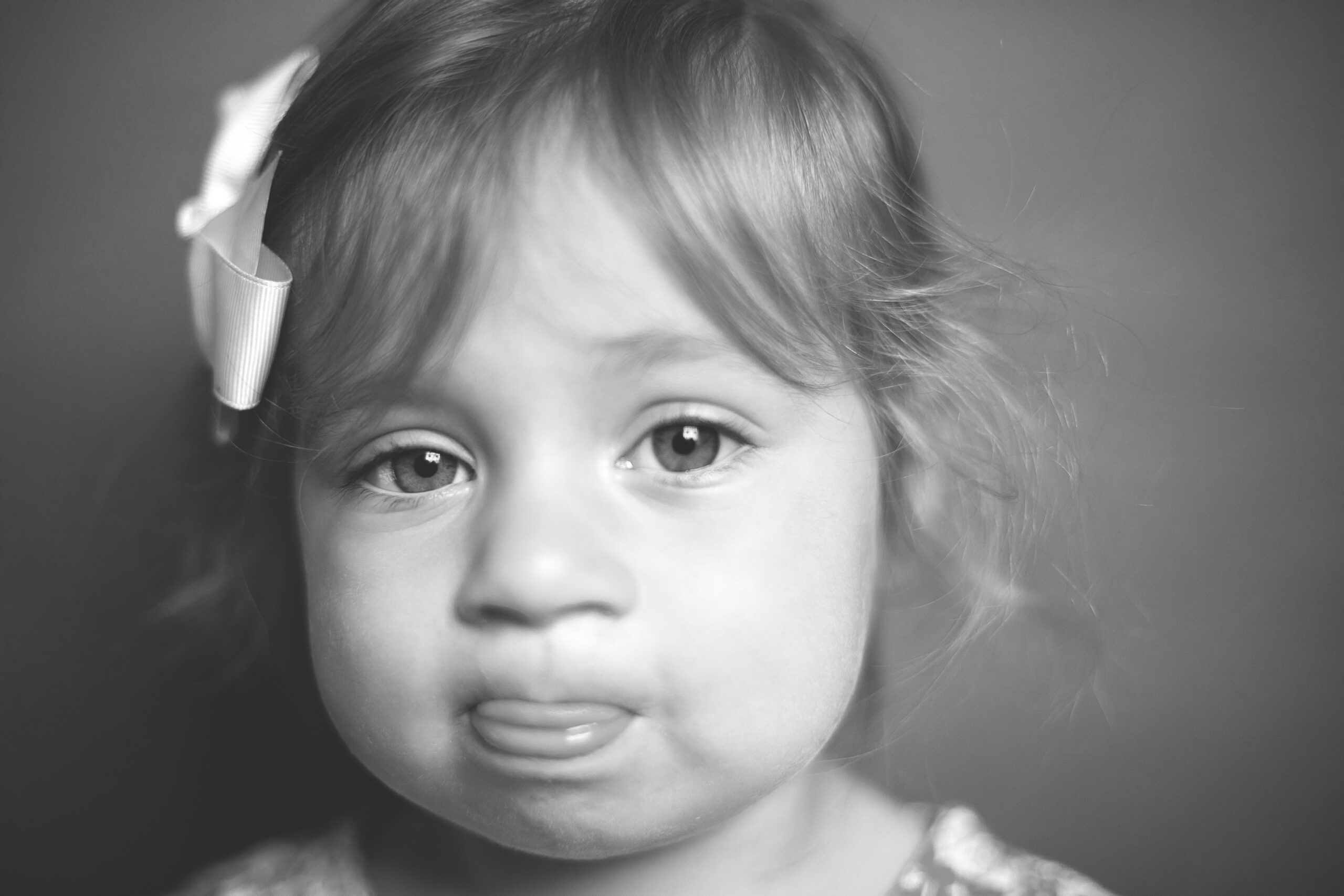 toddler girl sticking tongue at camera during baltimore preschool photography day