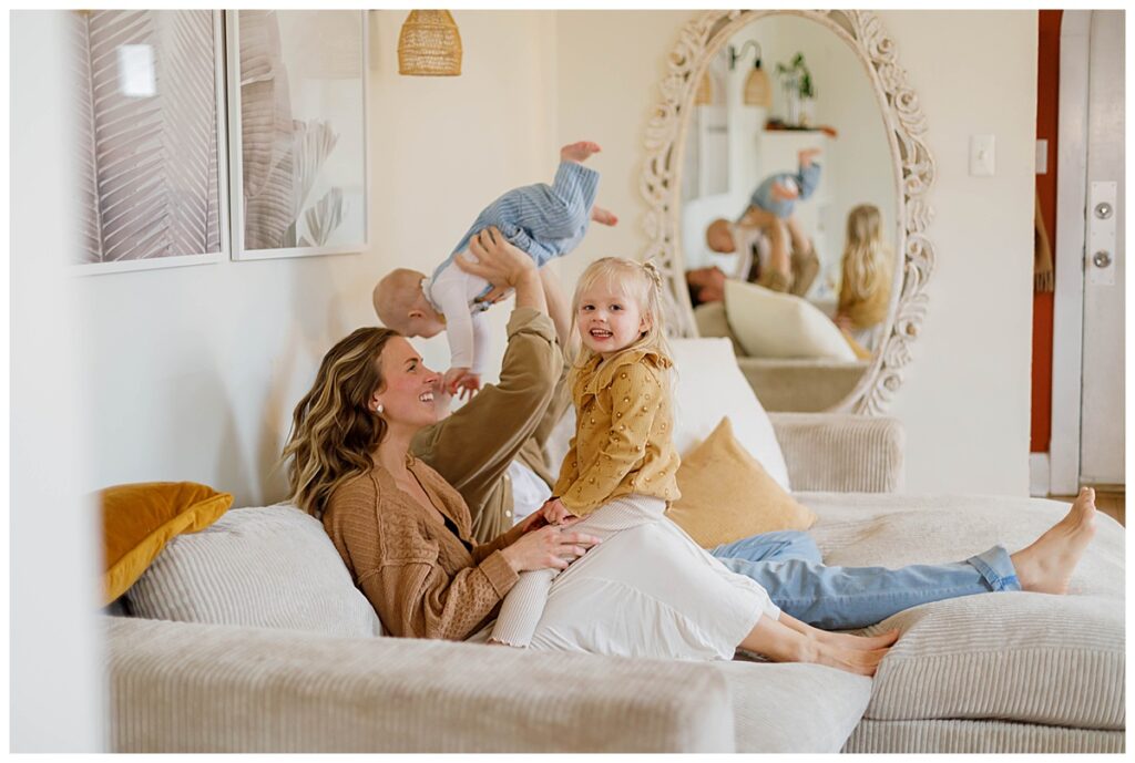 mom holding daughter during in home family photos Baltimore 