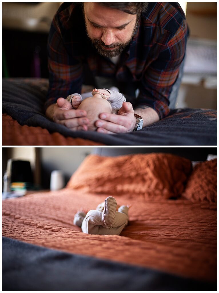 dad cradling infant's head on bed