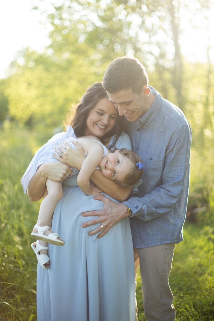 family snuggling together during maternity photo session