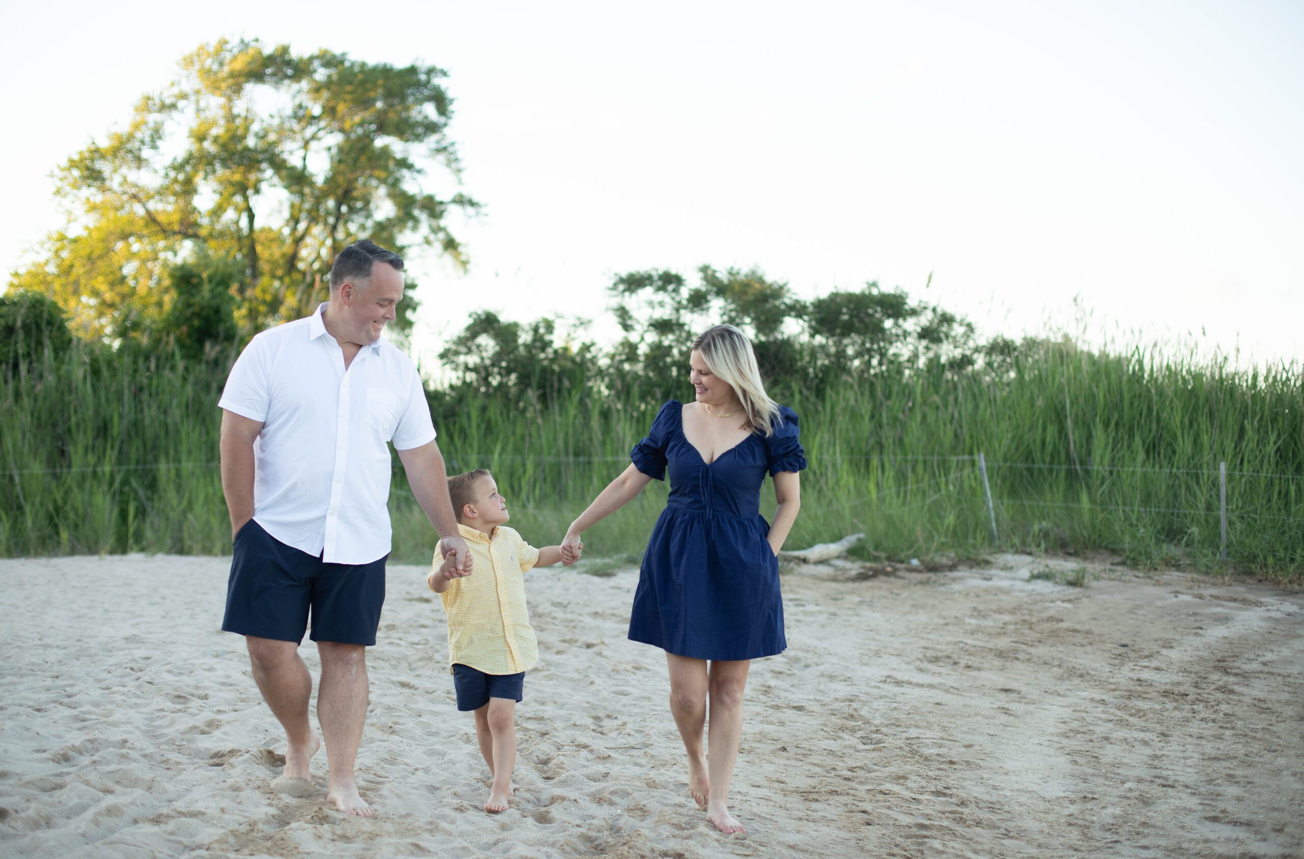 baltimore family walks along beach during family photos