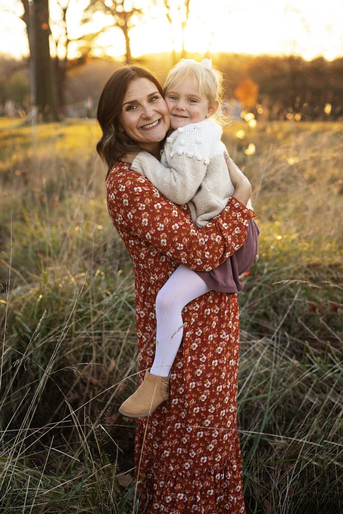 mom and daughter hugging during fall family session at hampton national historic site