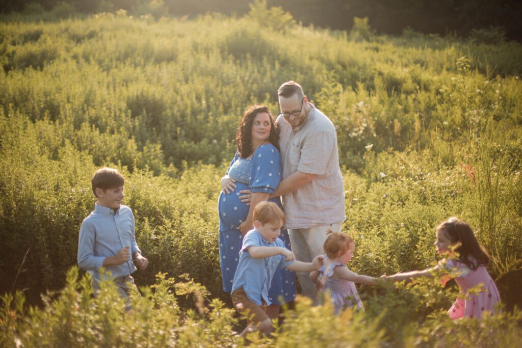kids running through field during baltimore family photo session