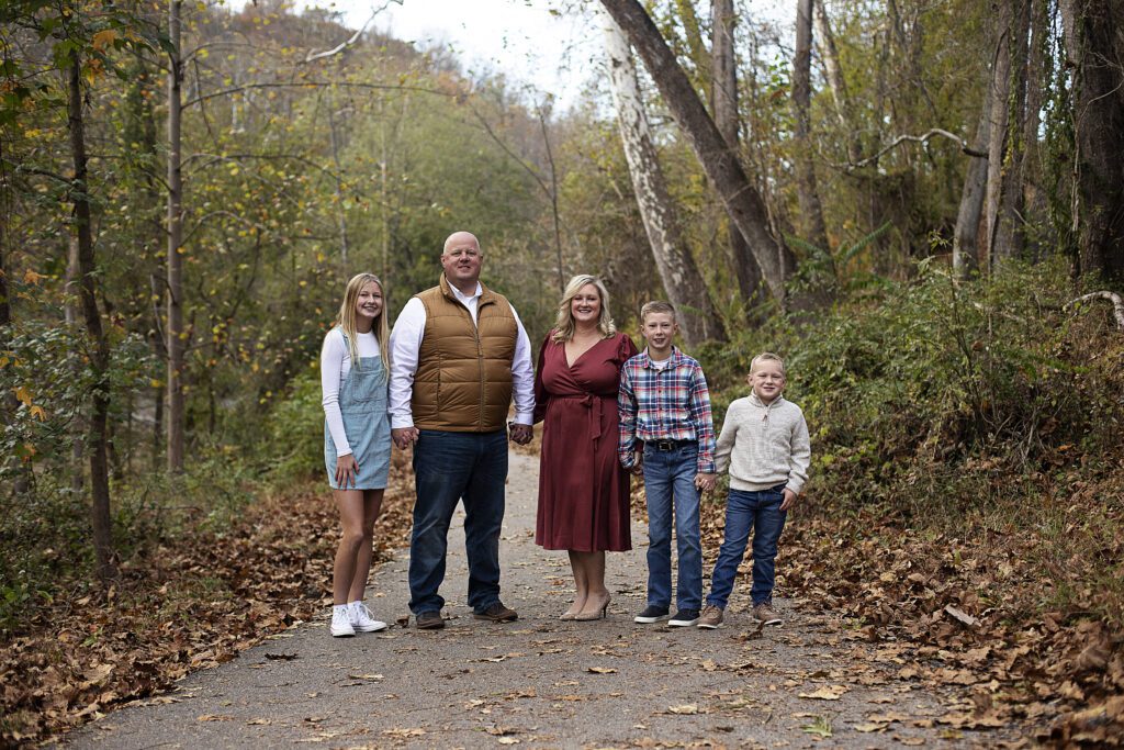 Family laughing under fall foliage in Patapsco Valley State Park