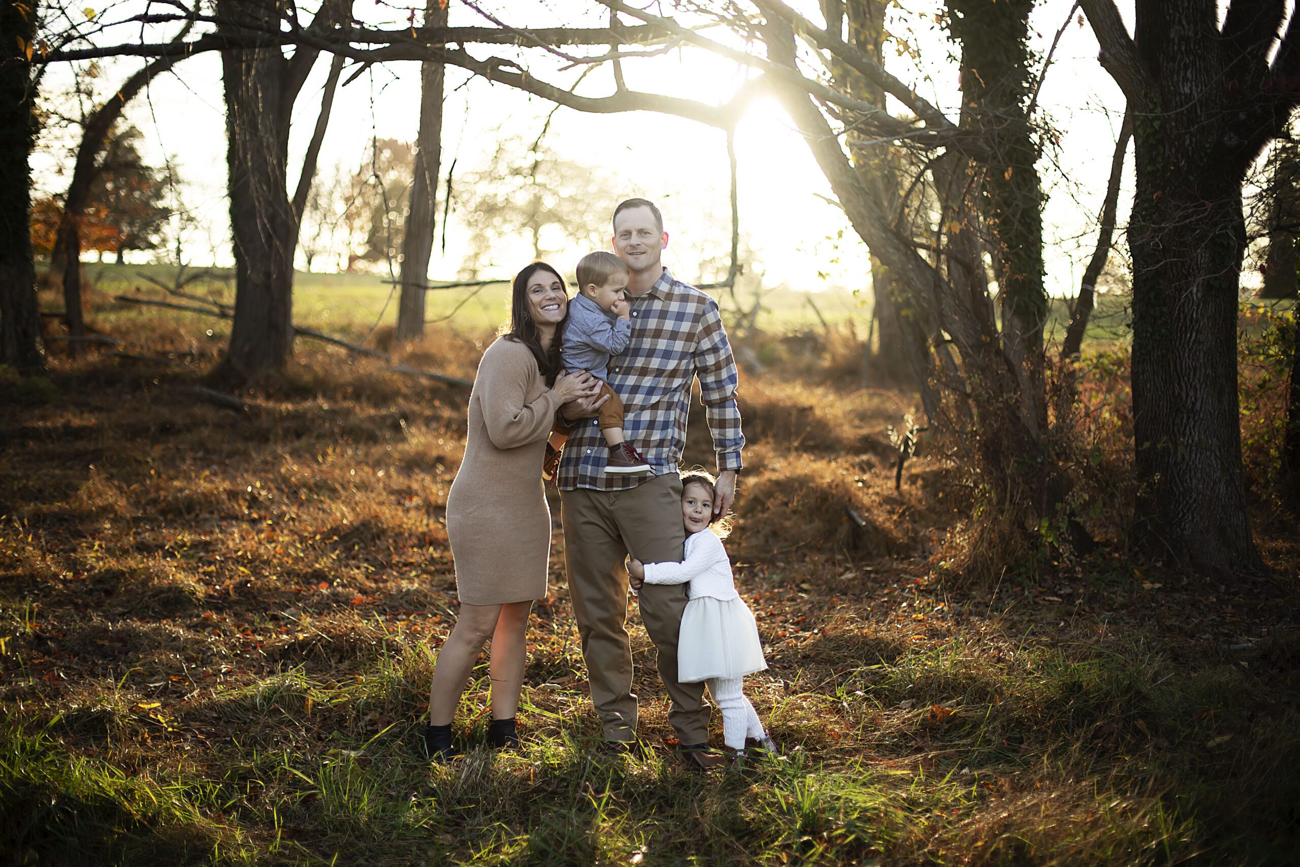 Family cuddling at Hampton National Historic Site during fall photo session