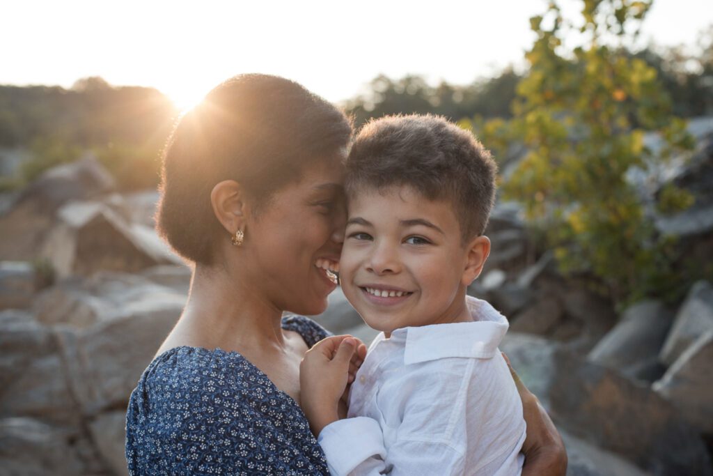 mom holding son at great falls park during family photo session