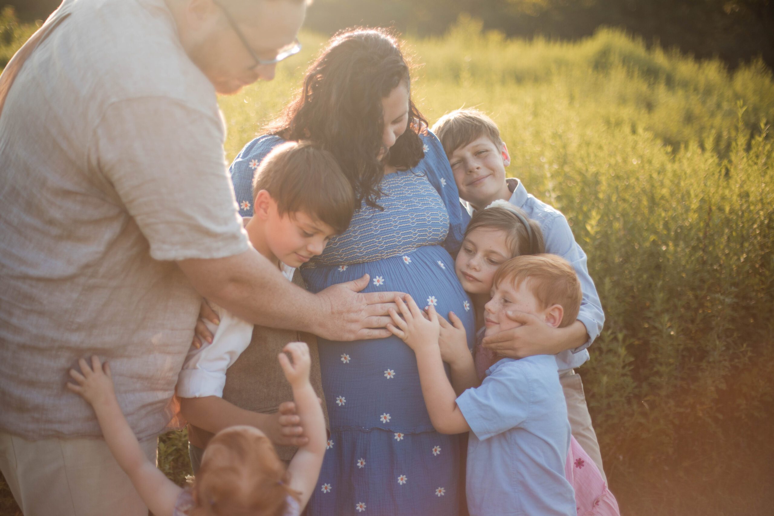 family hugging at cromwell valley park during family photo session